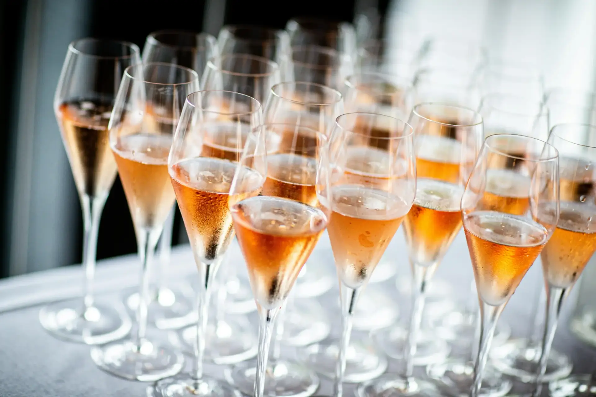 several champagne filled with Rose fllutes